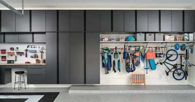 a garage with a lot of storage space and a bicycle hanging on the wall .